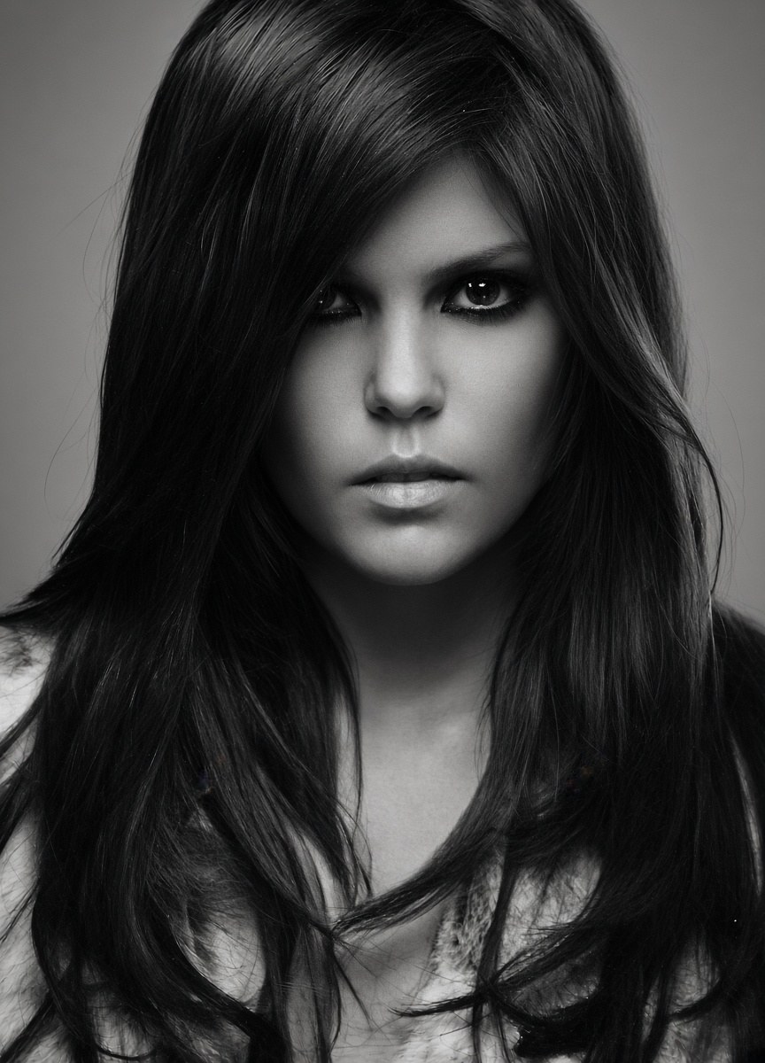 Black and white editorial portrait, long layered dark hair